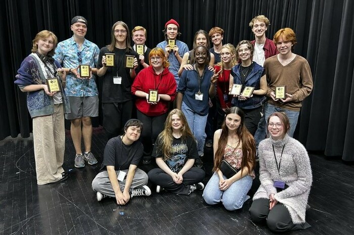 Drama students holding their awards