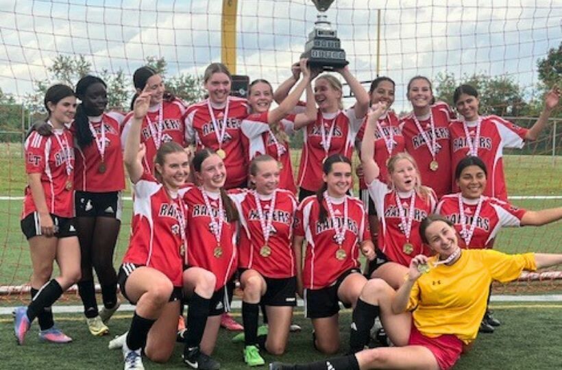 Girls Soccer Team With Championship Trophy
