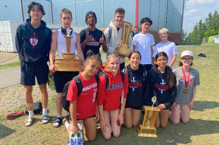 Grade 9 Track & Field athletes with 3 trophies