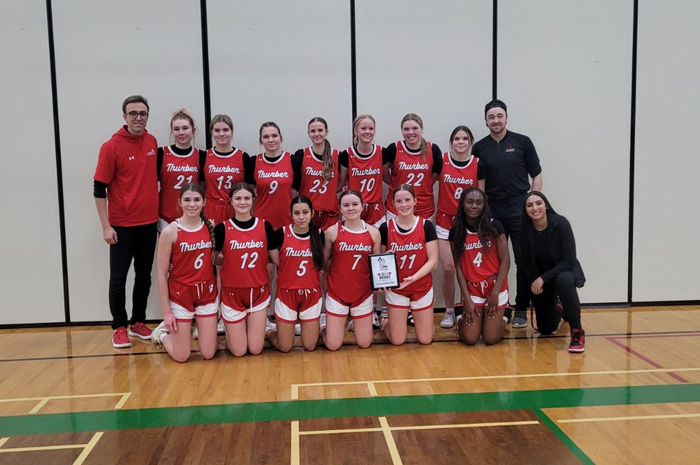 JV Girls Basketball with trophy