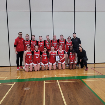 JV Girls Basketball with trophy